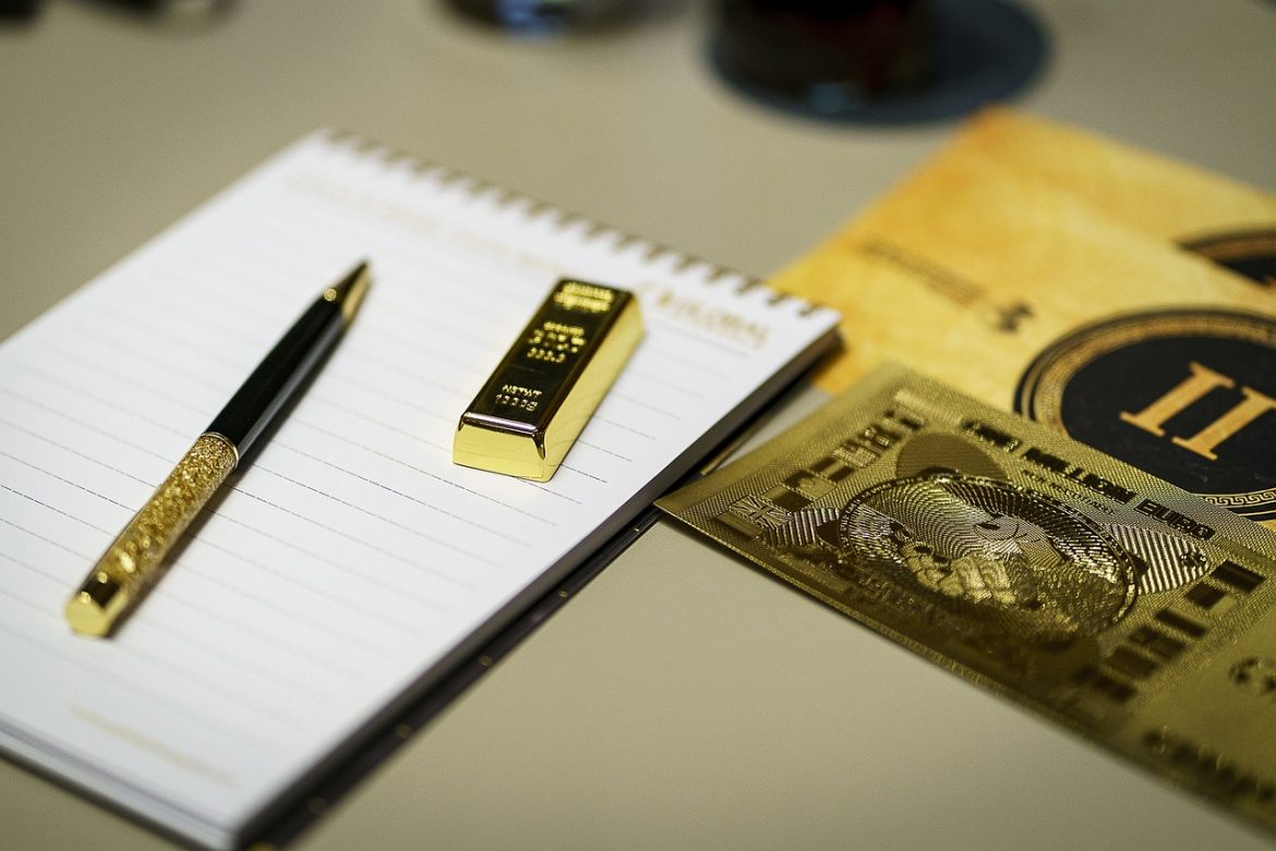 gold and paper pen